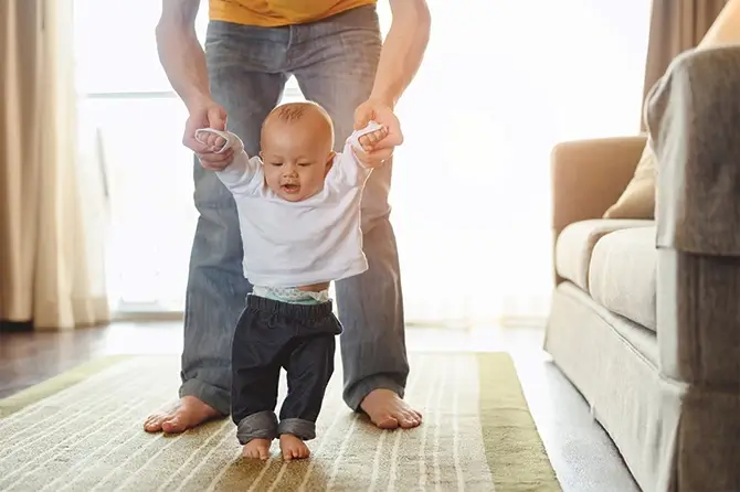 Dad Showing Baby How To Walk